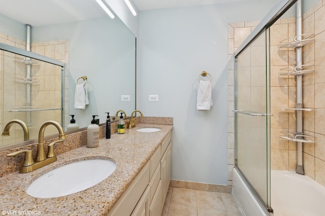 full bathroom with a sink, baseboards, combined bath / shower with glass door, and tile patterned flooring