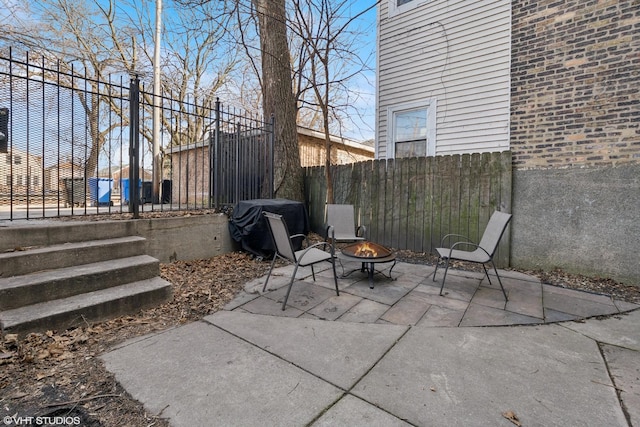 view of patio / terrace with fence and an outdoor fire pit