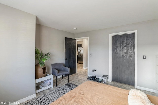 sitting room with wood finished floors and baseboards