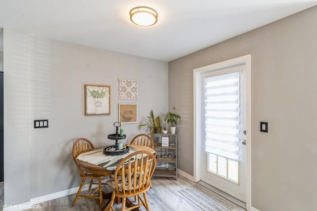 dining area with wood finished floors and baseboards