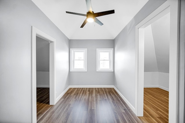 empty room featuring ceiling fan, baseboards, and wood finished floors