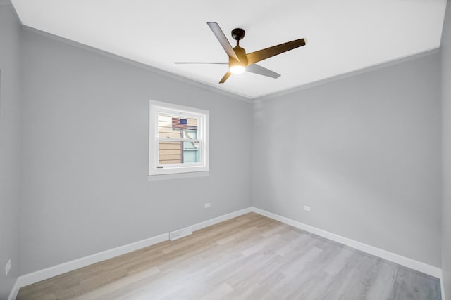 spare room with light wood-type flooring, baseboards, visible vents, and a ceiling fan