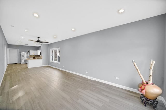 unfurnished living room with light wood-style flooring, recessed lighting, baseboards, and ceiling fan