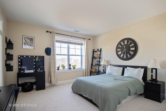 carpeted bedroom with visible vents and baseboards