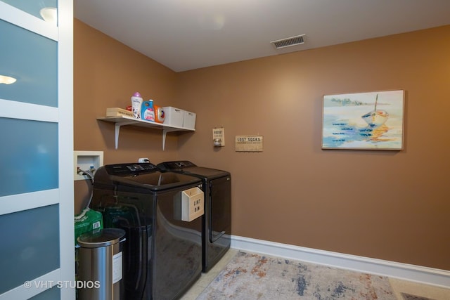 laundry room with visible vents, washer and dryer, light tile patterned floors, baseboards, and laundry area