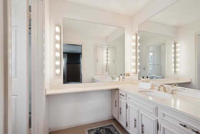 bathroom featuring double vanity and a sink