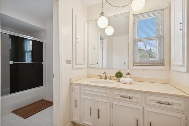 bathroom with tile patterned floors, vanity, and shower / bath combination with glass door