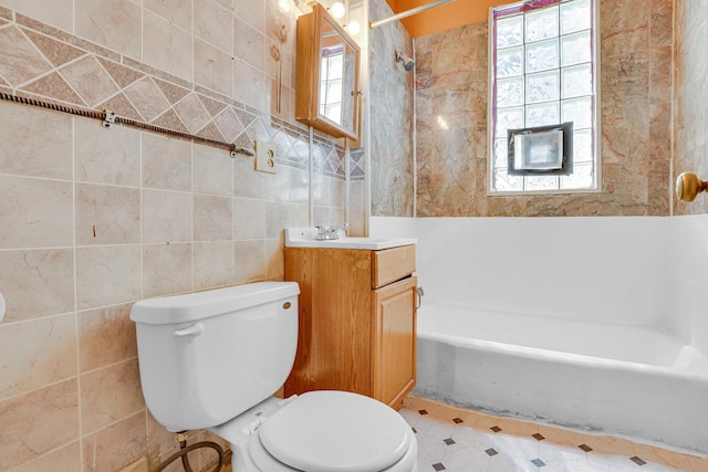 full bathroom with shower / bath combination, vanity, toilet, and tile walls