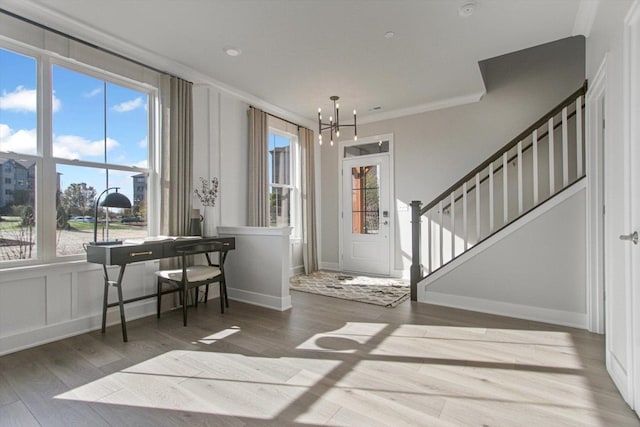 entrance foyer with plenty of natural light, stairs, and wood finished floors