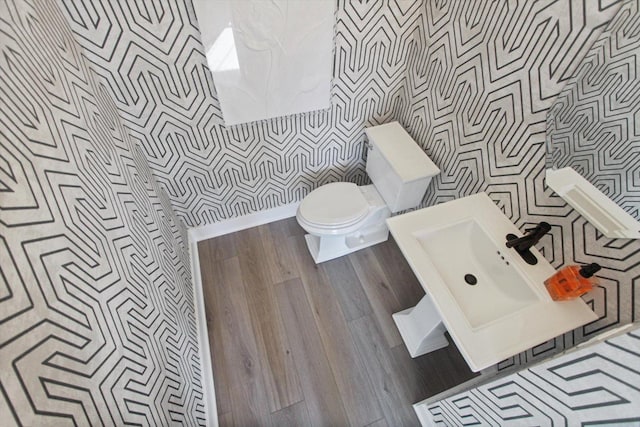 bathroom featuring toilet and wood finished floors