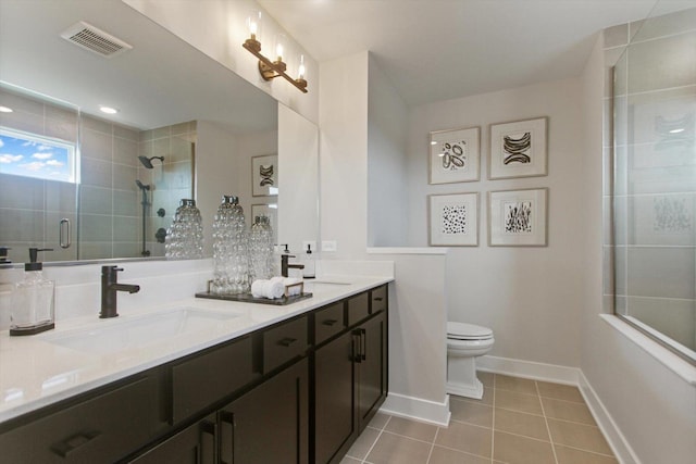 bathroom featuring a sink, visible vents, tile patterned floors, double vanity, and a stall shower