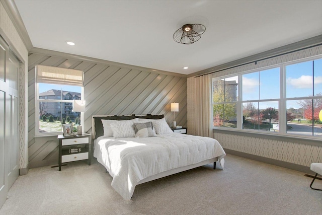 carpeted bedroom with wallpapered walls, multiple windows, and recessed lighting