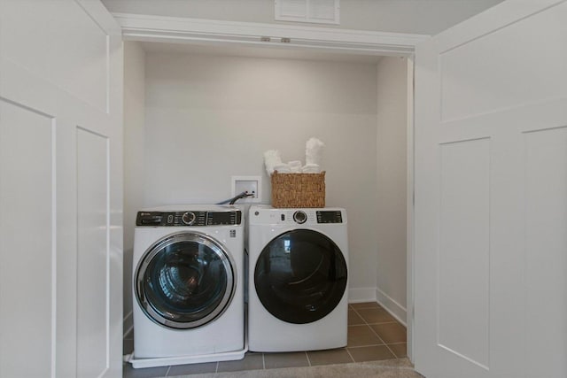 laundry area with tile patterned flooring, laundry area, visible vents, and washing machine and clothes dryer