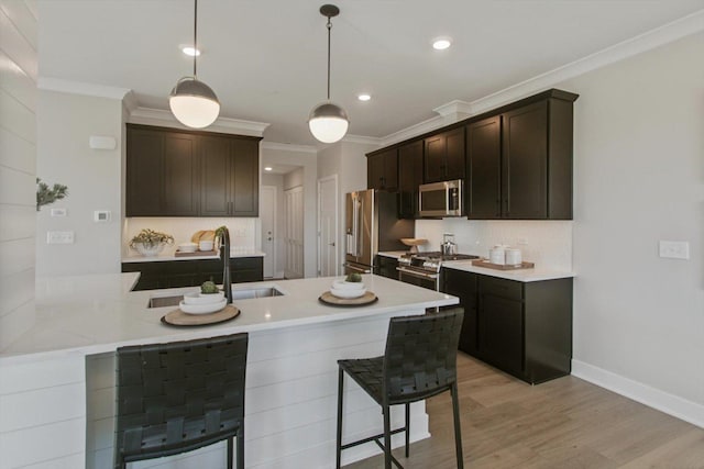 kitchen featuring a sink, backsplash, a kitchen breakfast bar, and high quality appliances