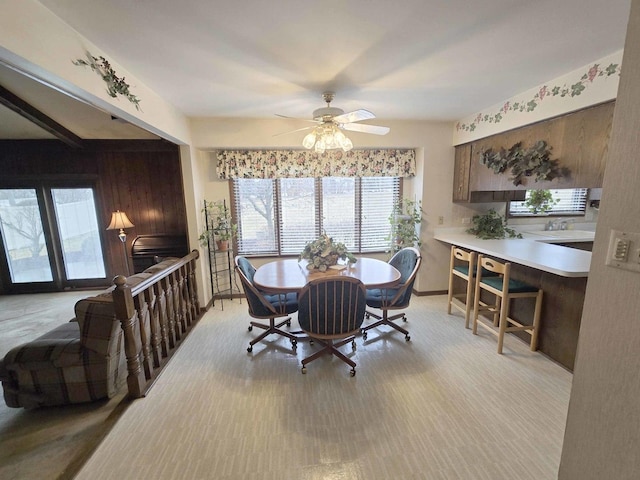 dining room featuring a ceiling fan and baseboards