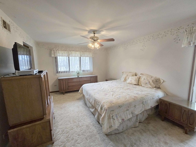 bedroom featuring visible vents, light colored carpet, and ceiling fan