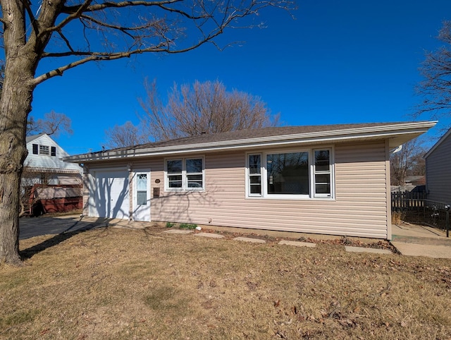 ranch-style house with a front yard and fence