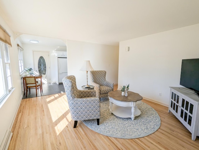 sitting room featuring baseboards and wood finished floors