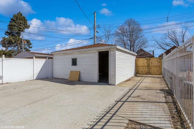 garage with a gate and fence