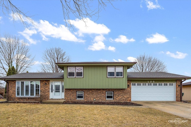 tri-level home featuring brick siding, an attached garage, driveway, and a front lawn