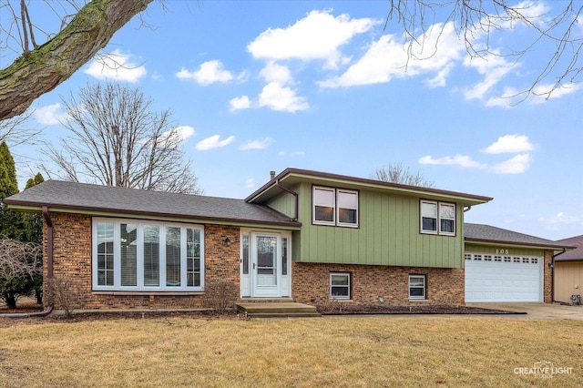 tri-level home featuring brick siding, driveway, and a front lawn