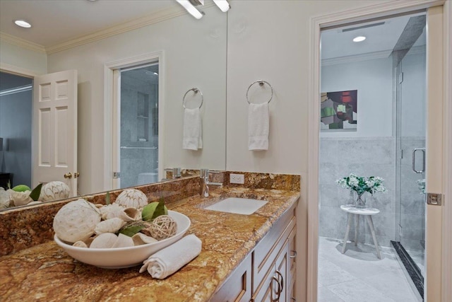 bathroom featuring a stall shower, vanity, and ornamental molding