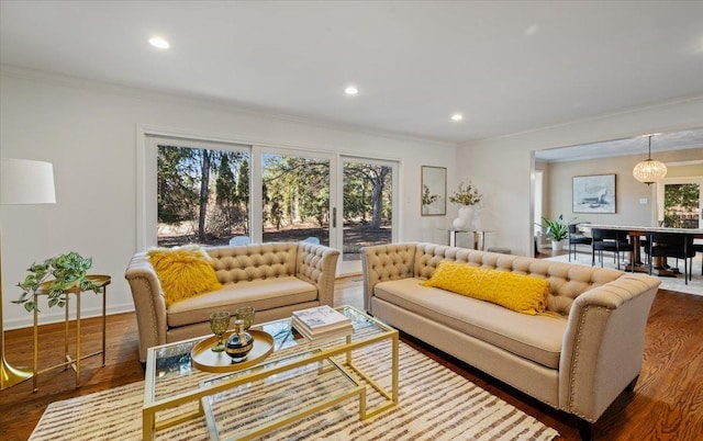 living room featuring recessed lighting, crown molding, baseboards, and wood finished floors