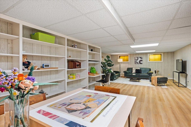 interior space featuring wood finished floors and a drop ceiling