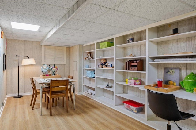 dining area featuring wooden walls and wood finished floors