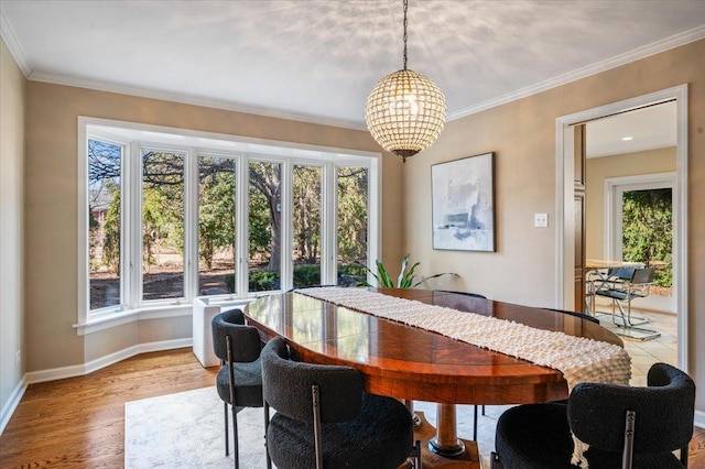 dining room with baseboards, plenty of natural light, and crown molding