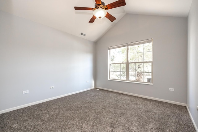 spare room with visible vents, baseboards, vaulted ceiling, a ceiling fan, and dark colored carpet