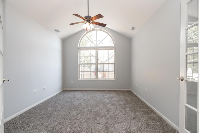 unfurnished room featuring baseboards, visible vents, lofted ceiling, and carpet floors