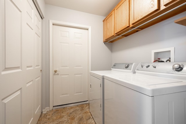 clothes washing area with cabinet space and independent washer and dryer