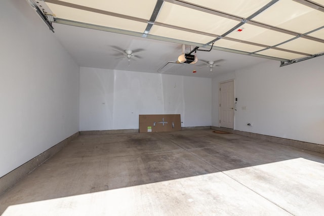 garage with a garage door opener and baseboards