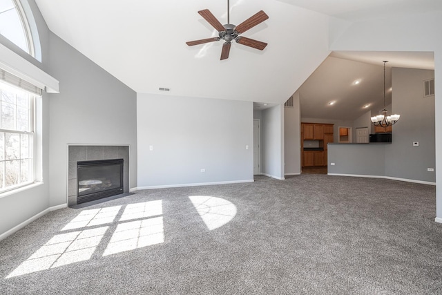 unfurnished living room with a tiled fireplace, carpet flooring, baseboards, and visible vents