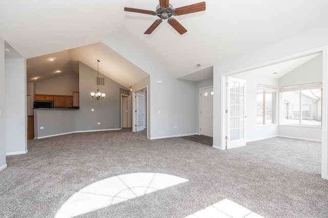 unfurnished living room with baseboards, visible vents, carpet floors, vaulted ceiling, and ceiling fan with notable chandelier