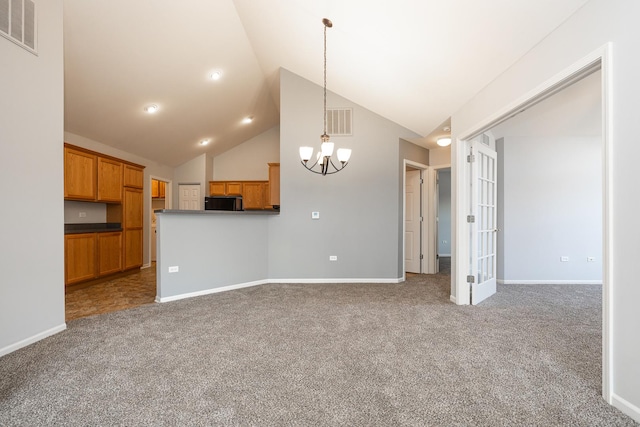 unfurnished living room with an inviting chandelier, carpet, visible vents, and baseboards