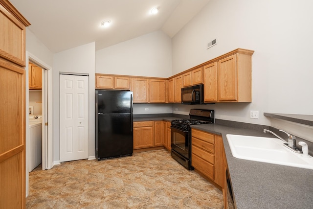 kitchen featuring visible vents, black appliances, a sink, washer / clothes dryer, and dark countertops