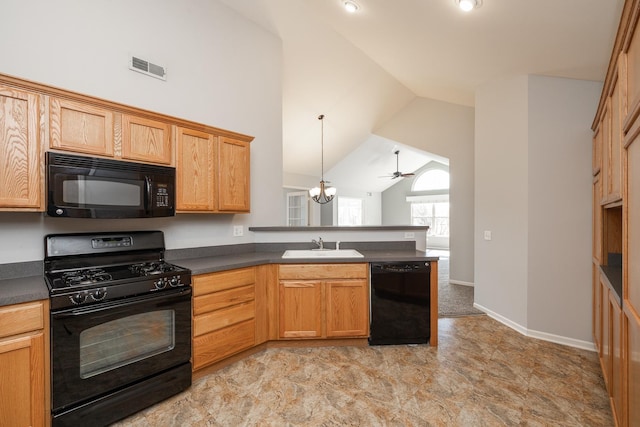 kitchen with visible vents, dark countertops, black appliances, and a peninsula