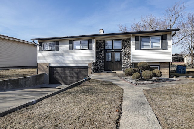 view of front of home with brick siding, driveway, and a garage