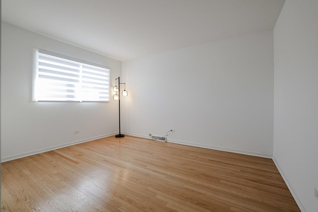 unfurnished room featuring light wood-style flooring and baseboards