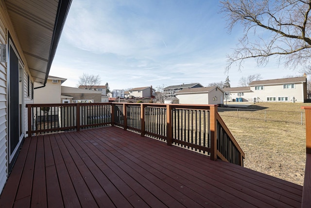 deck featuring a yard, a fenced backyard, and a residential view