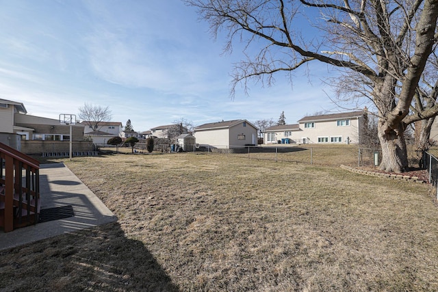 view of yard featuring a residential view and a fenced backyard