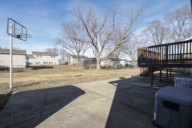 view of patio featuring a deck, fence, and a residential view