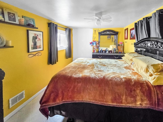 bedroom featuring a ceiling fan, visible vents, and baseboards