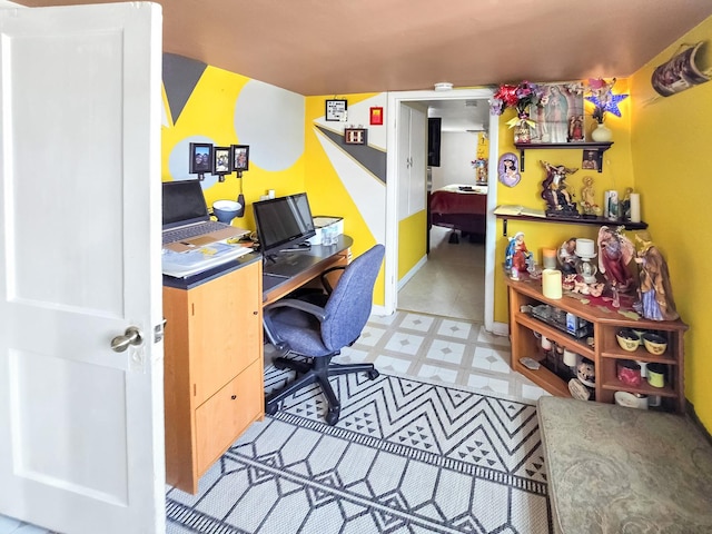 home office featuring baseboards and tile patterned floors