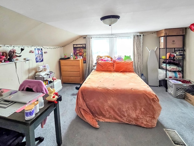 bedroom with lofted ceiling, carpet, and visible vents