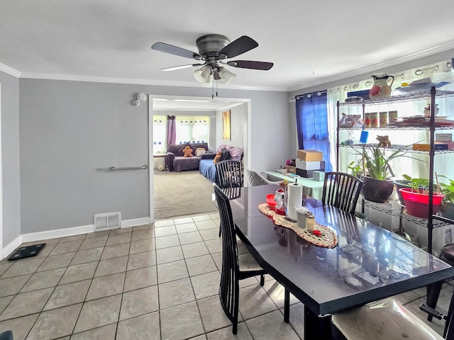 dining area featuring visible vents, ornamental molding, ceiling fan, tile patterned flooring, and baseboards