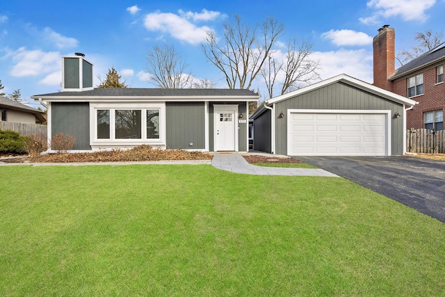 view of front of house with a chimney, fence, and a front lawn