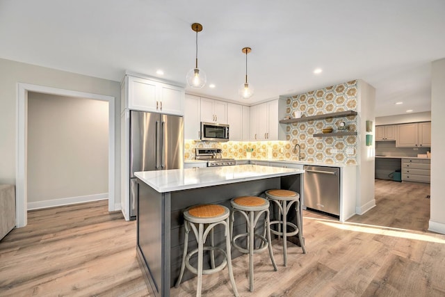 kitchen with light countertops, appliances with stainless steel finishes, open shelves, light wood finished floors, and tasteful backsplash